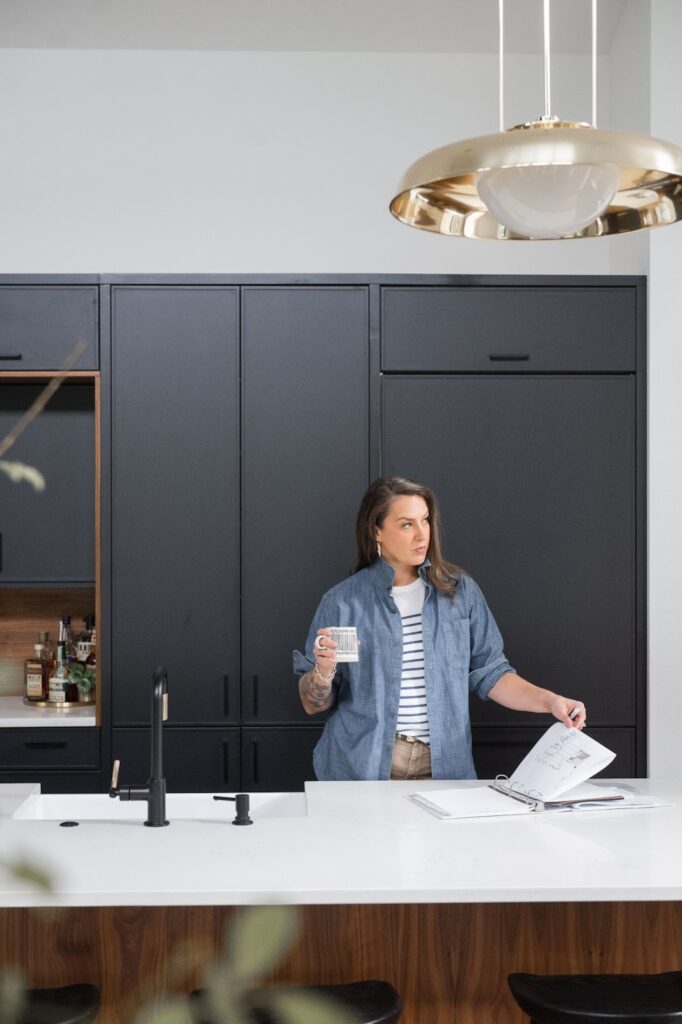 Interior designer Stacy reading in a kitchen